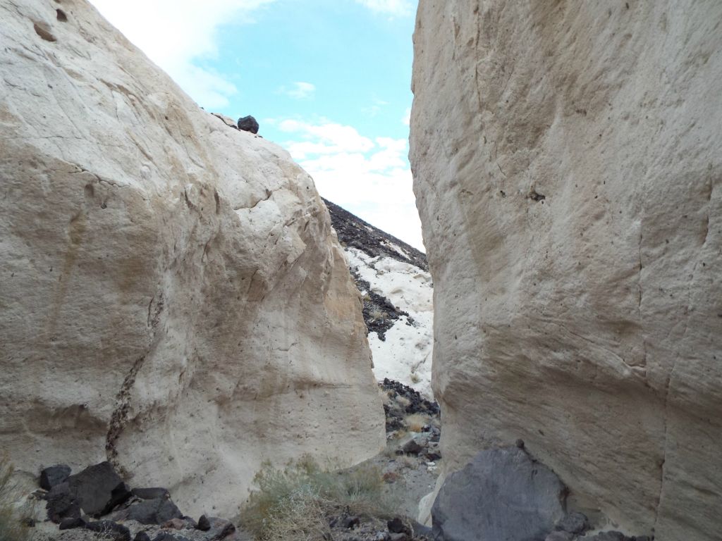 Through the opening in the narrows, tafoni formations are visible climbing up the hillside: