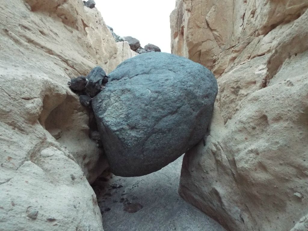 Taking a closer look, notice how the round boulder can be crawled under or climbed over: