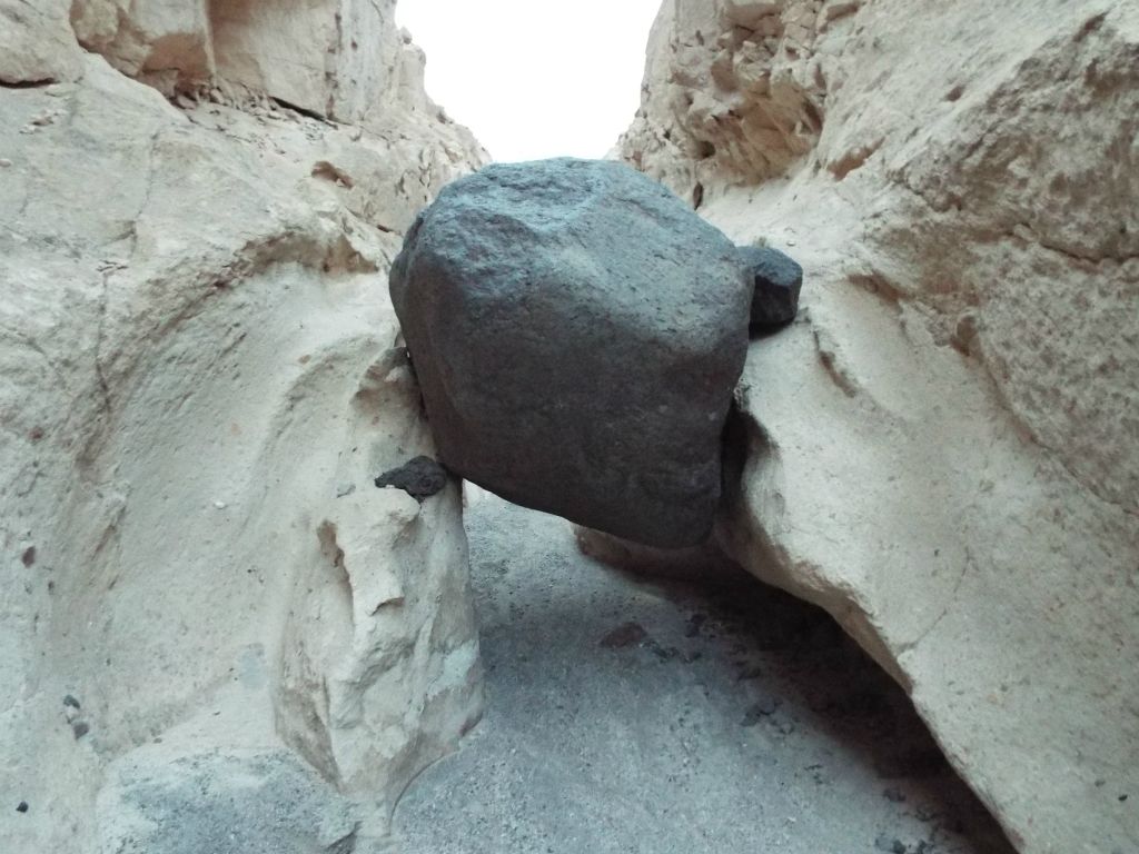 Check out the two polished dry falls on either side of the boulder.  It looks like when flash floods sweep down this canyon, the water flow pours over above the boulder: