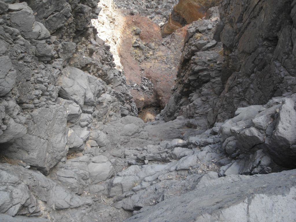 Looking straight down the 170 foot 2nd dry fall.  In the upper middle portion of the picture (red part), you can see how there is a very short ledge before the 90 foot 3rd major dry fall tumbles over: