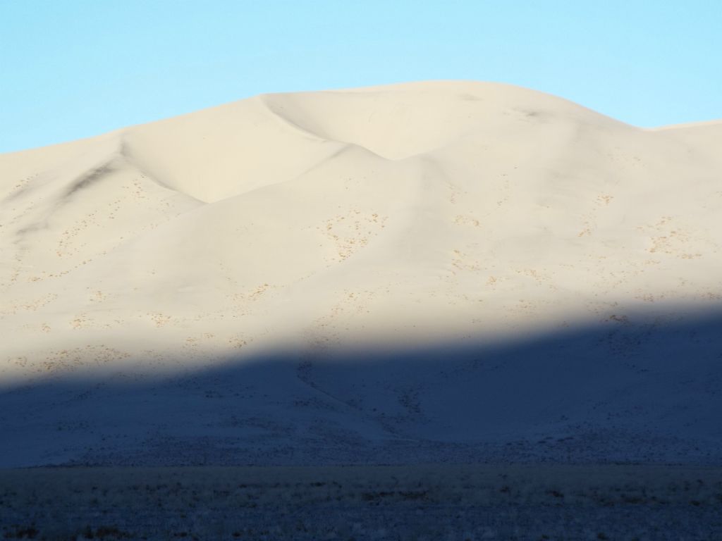 As the dark shadows descend down the dunes, the beautiful white sand is revealed: