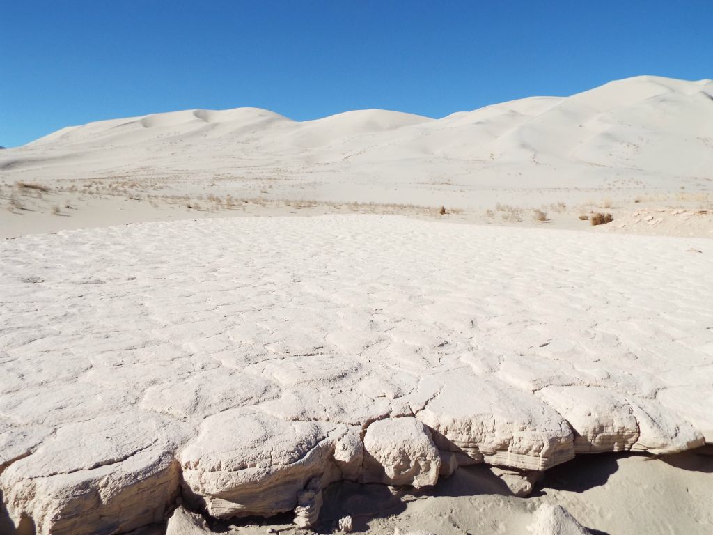 Looking across the dried mud toward the sand mountain of the Eureka Dunes: