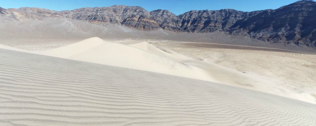 Panoramic view looking across some sand patterns toward the northern end of the Eureka Dunes: