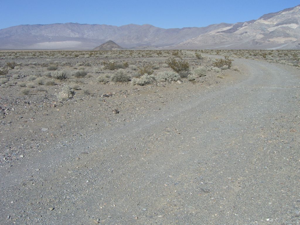 Driving on the Big Four Mine Road.  Up ahead you can see Lake Hill on the left.  A little farther beyond, also on the left are the Panamint Dunes: