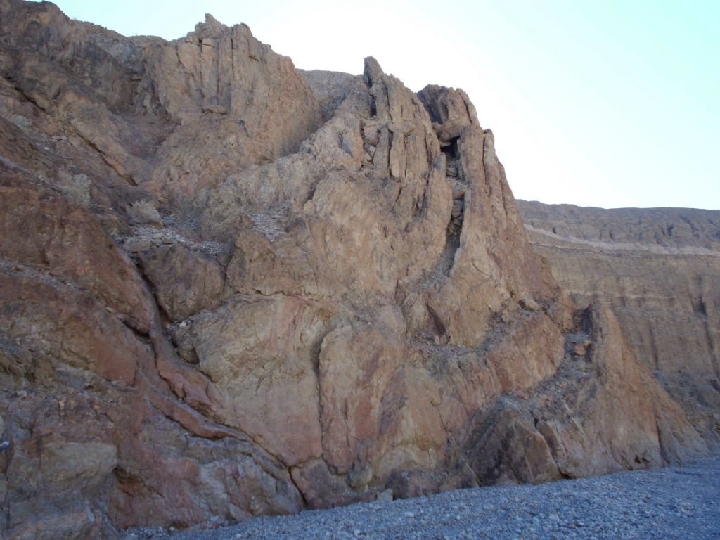 Notice the curved rock shelves rising above the canyon floor: