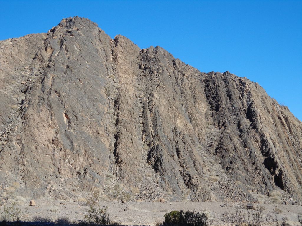 A towering wall of rock takes shape right away: