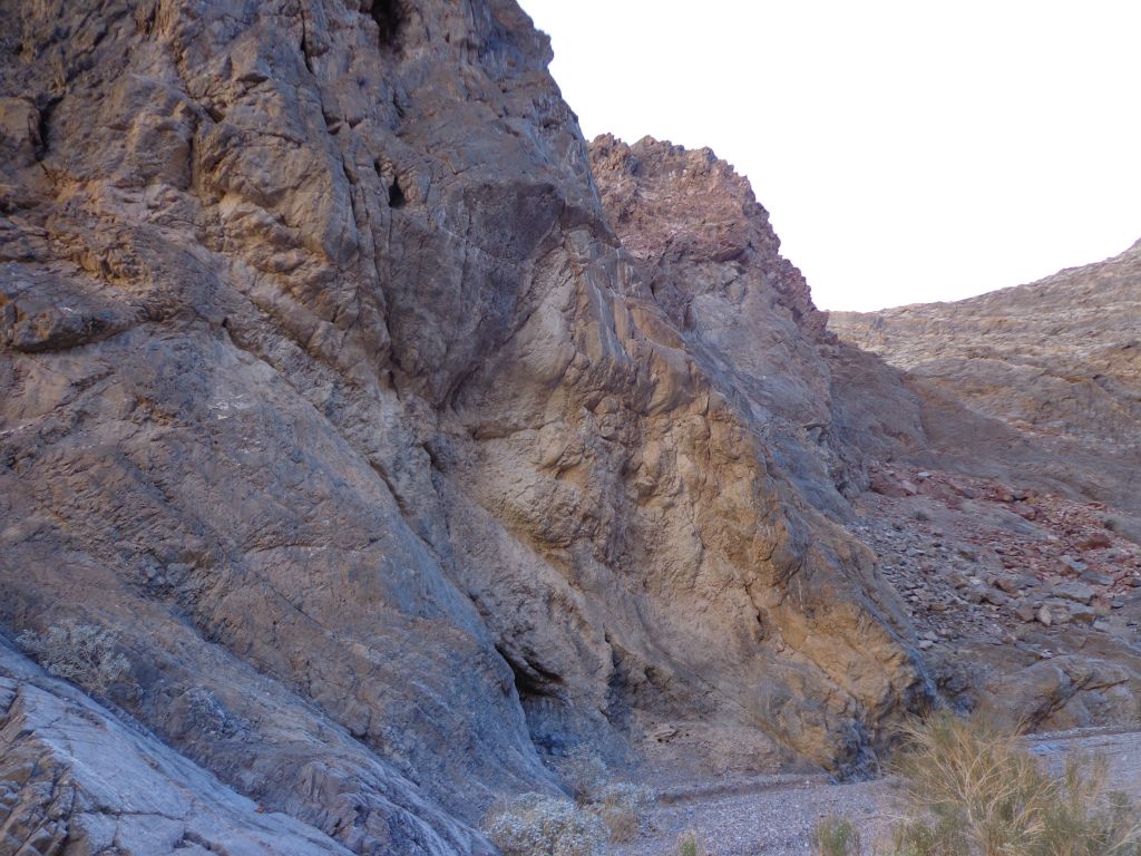 The canyon walls on the left side are streaked with colors: