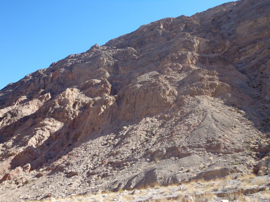 More loose rock hillsides and rugged cliffs above us: