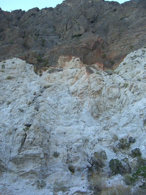 The white rock feels like it climbs halfway up the canyon wall, which towers above hikers in this area: