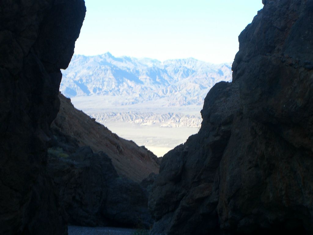 Looking between the canyon walls and back out the mouth of the canyon to the valley below: