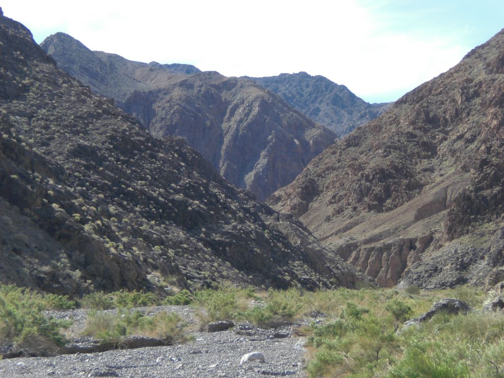 Diagonal hillsides sloping down to the wash: