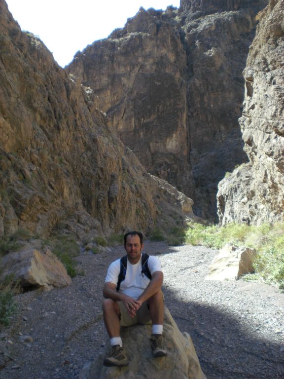 Steve resting on a rock in the middle of the canyon: