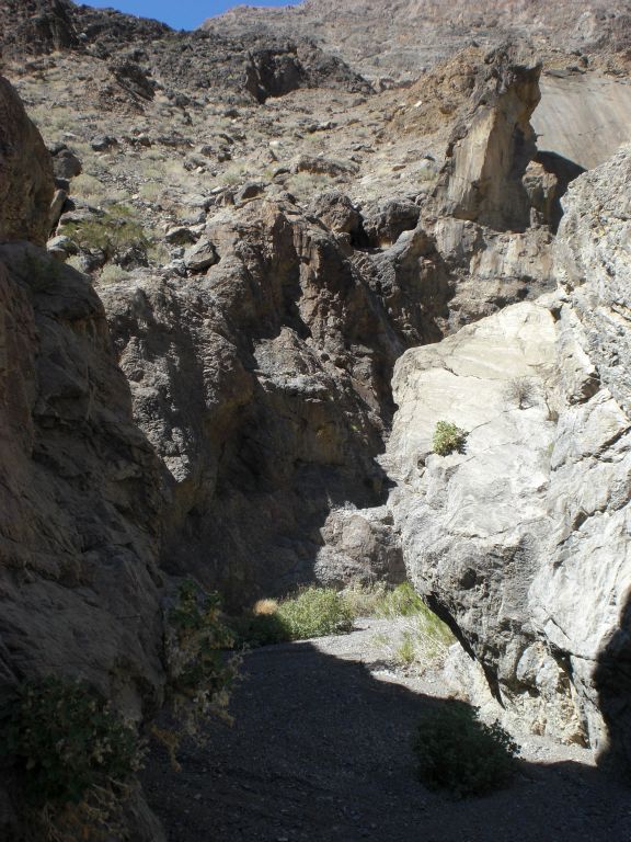A very narrow passage between jagged canyon walls:
