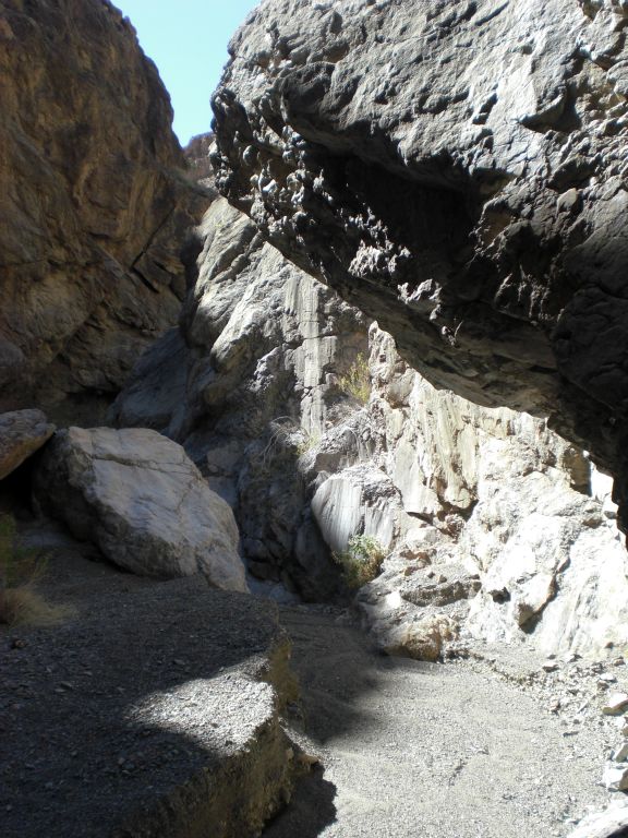 Walking directly under a massive overhanging rock: