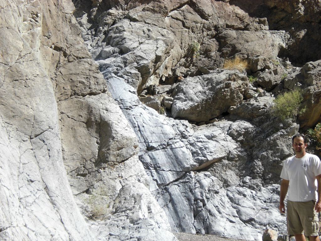 Two pictures of Steve standing by the 15 foot dry fall which put an end to his great adventure: