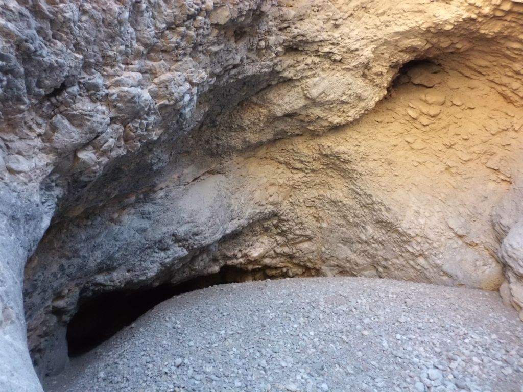 Walking into the grotto with very smooth gravel on the canyon floor: