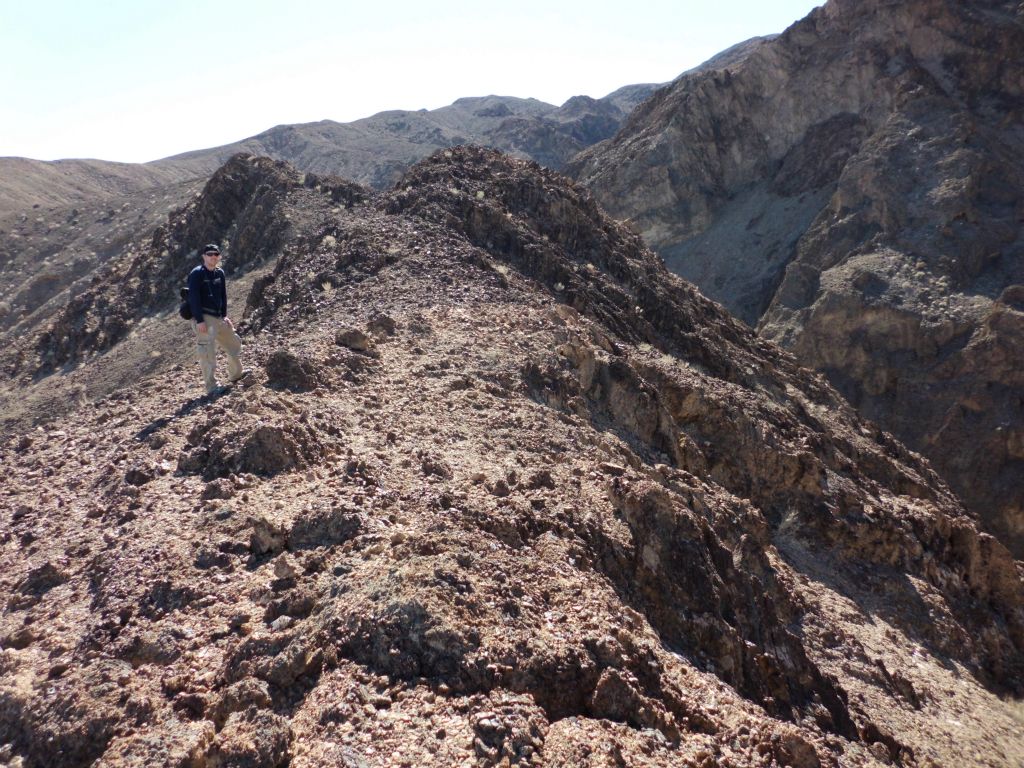 Tobin reaching the ridge on the east side which divides Bypass 2 Main and Tucki Bridge Canyon's gorge: