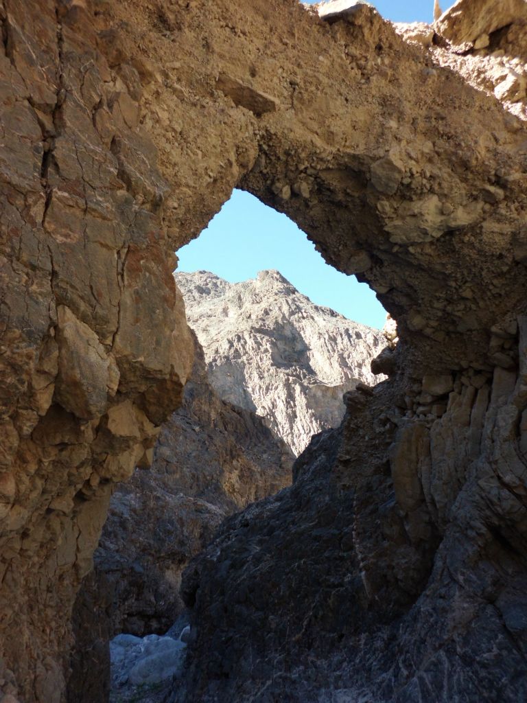 Looking through Tucki Bridge at the blue sky and distant peaks in the background:
