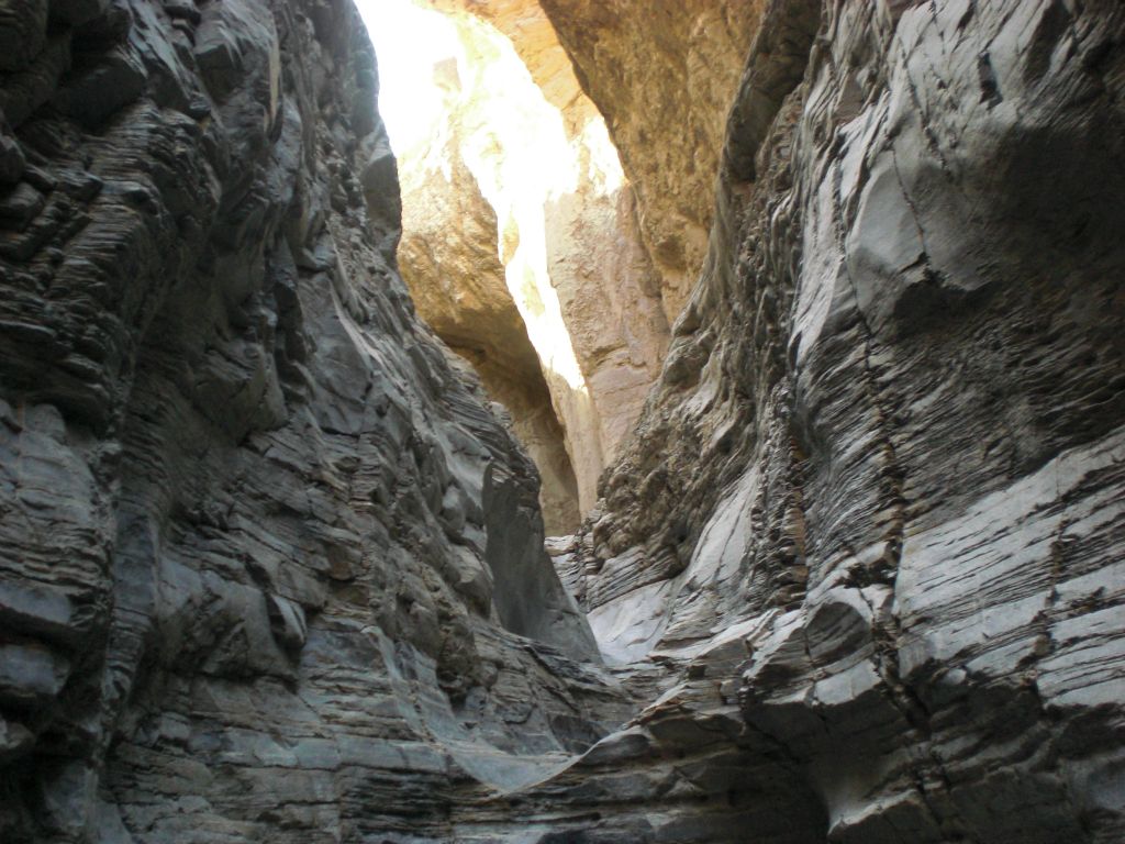 A nice picture showcasing the distinct color of the polished canyon walls with the sunlit higher walls in the distance: