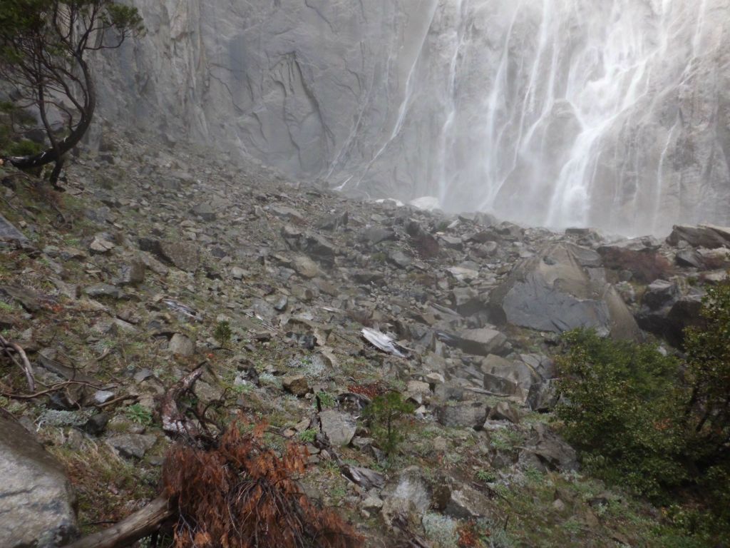 The final route to the actual base of the fall involves hiking across slippery rocks and getting drenched by the downpour of mist: