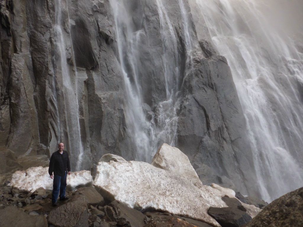 A picture of Charlie standing at the base next to blocks of snow: