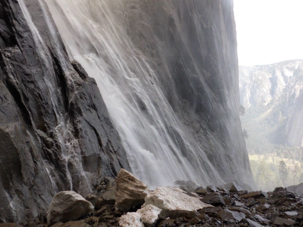 Blocks of snow, wet rocks, and the base of the waterfall: